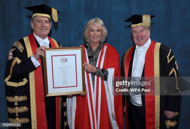 Camilla, Duchess of Cornwall receives her honorary doctorate from the Chancellor of the University of Chester Gyles Brandreth during the University...