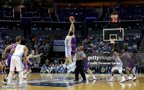 Luke Maye of the North Carolina Tar Heels tips off against Eli Pepper of the Lipscomb Bisons during the first round of the 2018 NCAA Men's Basketball...