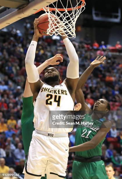 Shaquille Morris of the Wichita State Shockers drives to the basket against Darius George of the Marshall Thundering Herd in the second half during...