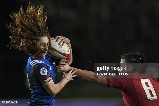 France's scrum-half Pauline Bourdon evades the tackle of Wales' number 8 Sioned Harries during the Women's Six Nations international rugby union...