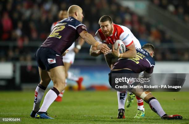 St Helens' Kyle Amor is tackled by Leeds Rhinos Carl Ablett and Brett Delaney during the Betfred Super League match at The Totally Wicked Stadium, St...