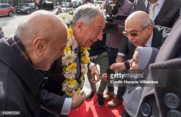 Portuguese President Marcelo Rebelo de Sousa reacts after receiving a garland of flowers by a little girl when arriving in the city's Central Mosque...