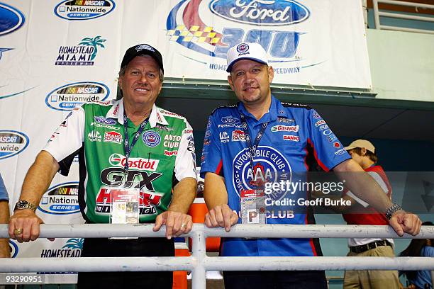 Car owner John Force and 2009 NHRA Funny Car Champion Robert Hight pose on pit road during the NASCAR Nationwide Series Ford 300 at Homestead-Miami...