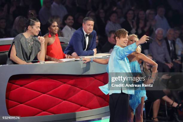 Heiko Lochmann and Kathrin Menzinger pose for a selfie with jury members Jorge Gonzalez , Motsi Mabuse and Joachim Llambi on stage during the 1st...