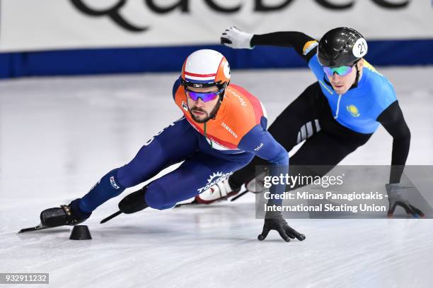 Sjinkie Knegt of the Netherlands skates against Denis Nikisha of Kazakstan in the men's 1000 meter preliminaries during the World Short Track Speed...