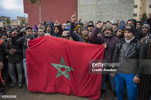 People shouts slogans and hold Flag of Morocco as they gather at Jerada city center during a demonstration demanding the fulfillment of government's...