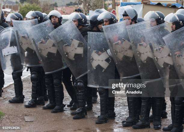 Police officials take security measures as people gather at Jerada city center to stage a demonstration demanding the fulfillment of government's...