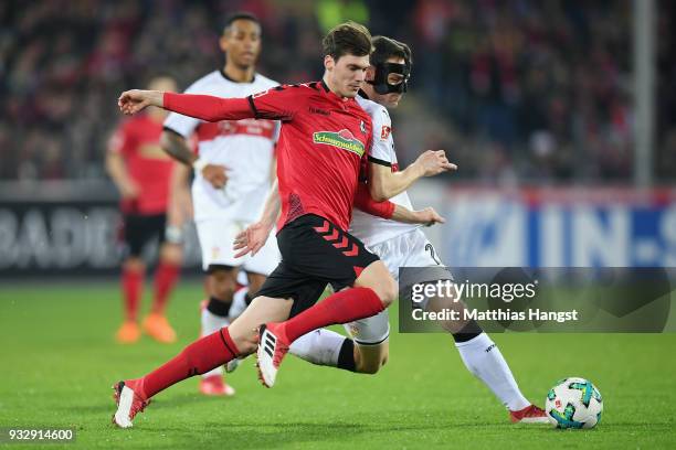 Pascal Stenzel of Freiburg is challenged by Christian Gentner of Stuttgart during the Bundesliga match between Sport-Club Freiburg and VfB Stuttgart...