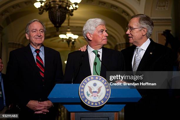 Senate Majority Leader Harry Reid hugs Sen. Chris Dodd as Sen. Tom Harkin looks on during a news conference following the Senate's cloture vote on...