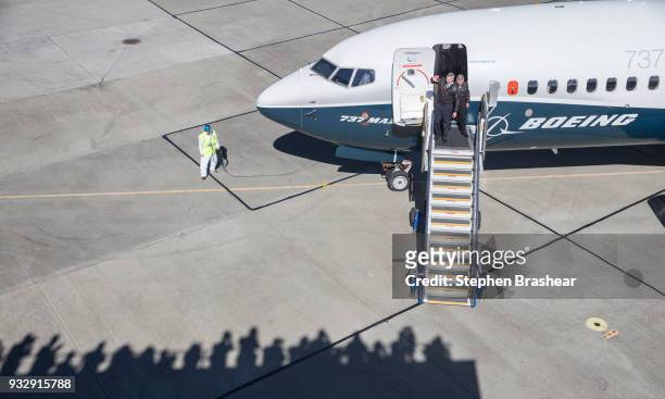 Boeing test pilots Jim Webb, left, and Keith Otsuka greet a crowd after completing the first flight of the Boeing 737 MAX 7, on March 16, 2018 in...