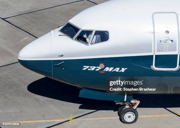 Boeing test pilot Jim Webb gives a thumbs-up from the cockpit of a 737 MAX 7 at Boeing Field, on March 16, 2018 in Seattle, Washington, after...