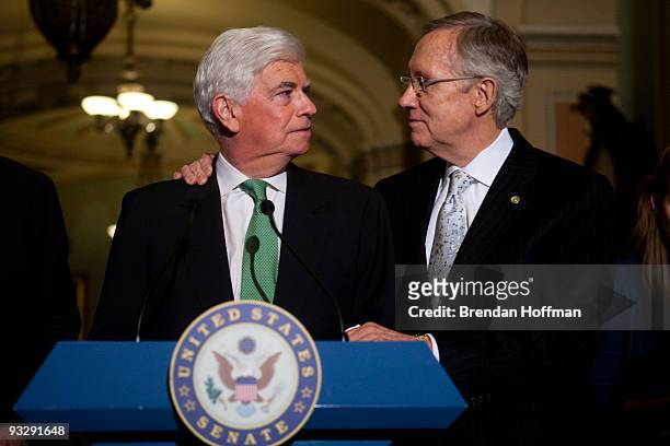Senate Majority Leader Harry Reid hugs Sen. Chris Dodd as during a news conference following the Senate's cloture vote on health care reform...