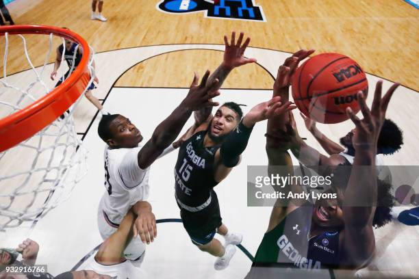 Malik Benlevi and D'Marcus Simonds of the Georgia State Panthers fight for a rebound with Tre Scott of the Cincinnati Bearcats during the game in the...