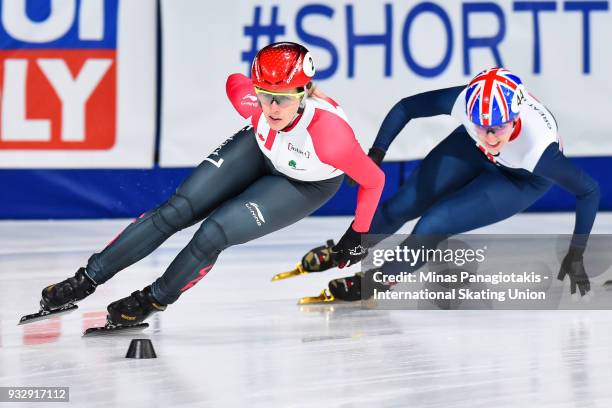 Marianne St-Gelais of Canada skates against Charlotte Gilmartin of Great Britain in the women's 1000 meter heats during the World Short Track Speed...