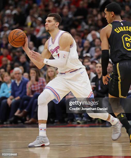 Zach LaVine of the Chicago Bulls passes near Derrick Williams of the Los Angeles Lakers at the United Center on January 26, 2018 in Chicago,...