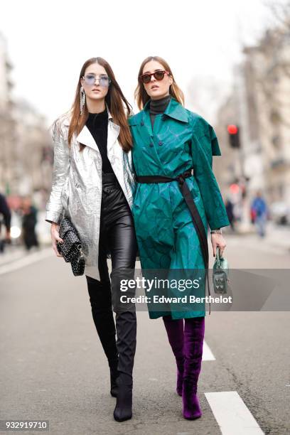 Guest wears sunglasses, one large earring, a black top, a white glossy silver coat, black leather skinny pants, a black studded handbag, black suede...