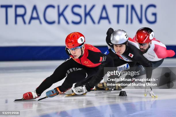 Tianyu Han of China takes the lead against Ryosuke Sakazume of Japan and Charles Hemelin of Canada in the men's 1000 meter heat during the World...