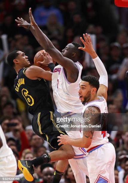 Derrick Williams of the Los Angeles Lakers tries to get off a shot against Jerian Grant and Denzel Valentine of the Chicago Bulls at the United...
