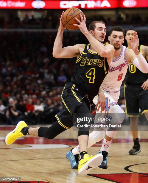 Alex Caruso of the Los Angeles Lakers drives past Zach LaVine of the Chicago Bulls at the United Center on January 26, 2018 in Chicago, Illinois. The...