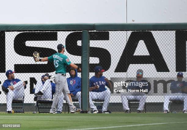 Kirk Nieuwenhuis of the Seattle Mariners watches the ball fly over the right field wall off of the bat of Drew Robinson of the Texas Rangers during...