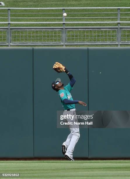 Dee Gordon of the Seattle Mariners catches a deep fly ball off the bat of Juan Centeno of the Texas Rangers during the third inning of a spring...