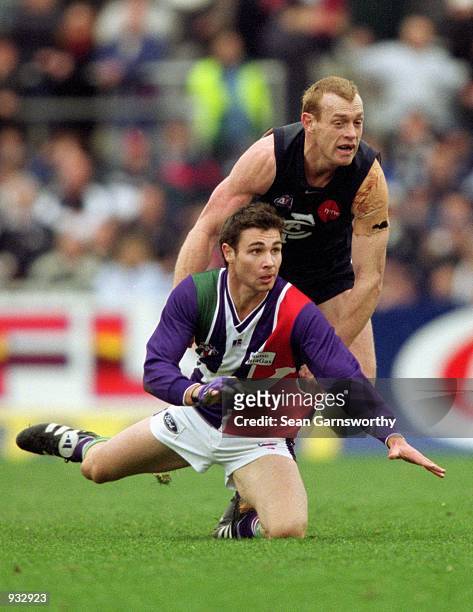 Troy Longmuir for Fremantle and Adrian Hickmott for Carlton in action during the round 16 AFL match played between the Carlton Blues and the...