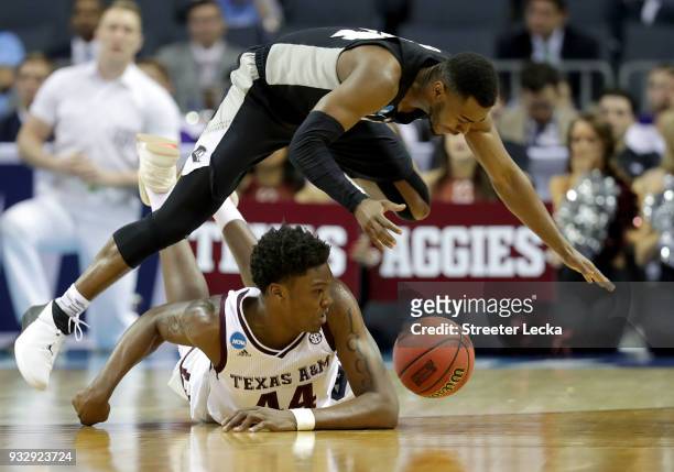 Robert Williams of the Texas A&M Aggies dives for ball possession againt Kyron Cartwright of the Providence Friars during the first round of the 2018...
