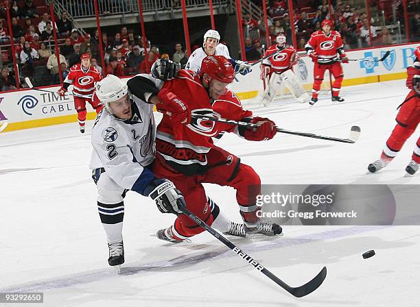 Matt Cullen of the Carolina Hurricanes battles for the puck against Lukas Krajicek of the Tampa Bay Lightning during an NHL game on November 21, 2009...