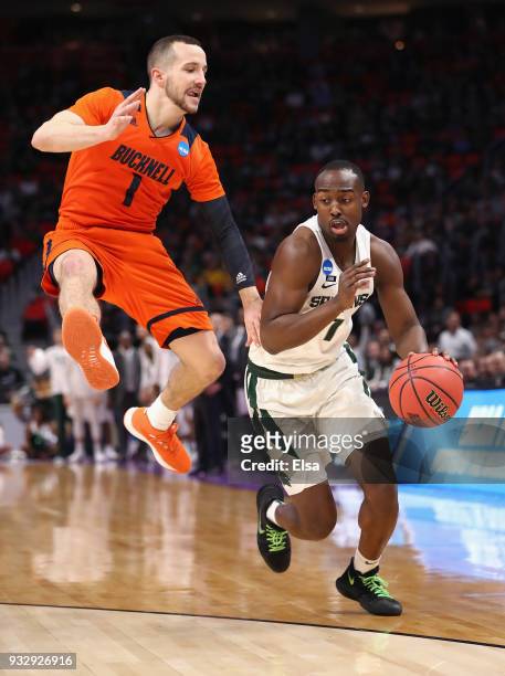 Kimbal Mackenzie of the Bucknell Bison defends Joshua Langford of the Michigan State Spartans during the first half in the first round of the 2018...