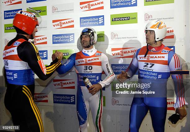 Armin Zoggeler of Italy is congratulated by David Moller of Germany and Albert Demtschenko of Russia after winning the World Cup Men's event during...