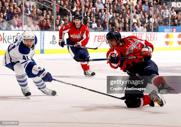 Nikolai Kulemin of the Toronto Maple Leafs tries to block the shot of Alex Ovechkin of the Washington Capitals during game action November 21, 2009...