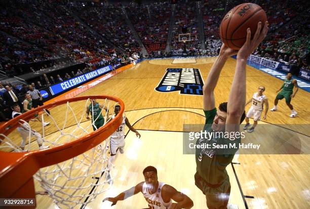 Jannson Williams of the Marshall Thundering Herd goes up for a dunk against the Wichita State Shockers during the first round of the 2018 NCAA Men's...