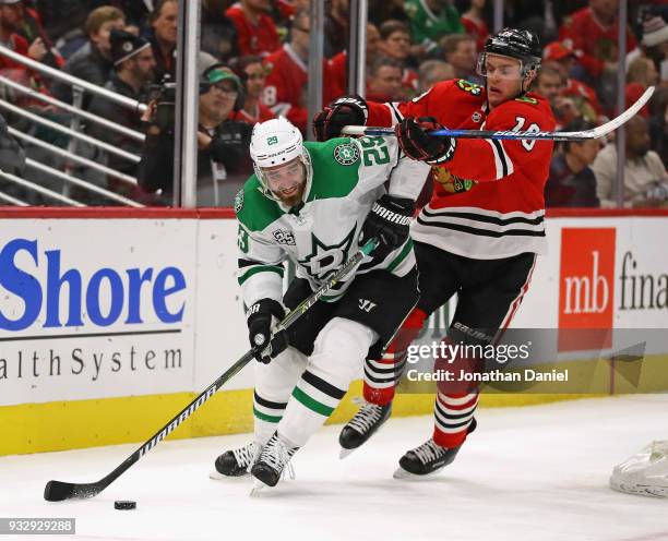 Greg Pateryn of the Dallas Stars is pressured by Jonathan Toews of the Chicago Blackhawks at the United Center on February 8 2018 in Chicago,...