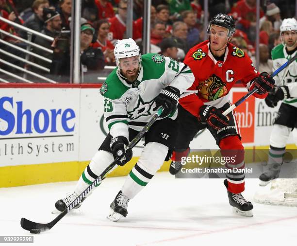 Greg Pateryn of the Dallas Stars is pressured by Jonathan Toews of the Chicago Blackhawks at the United Center on February 8 2018 in Chicago,...