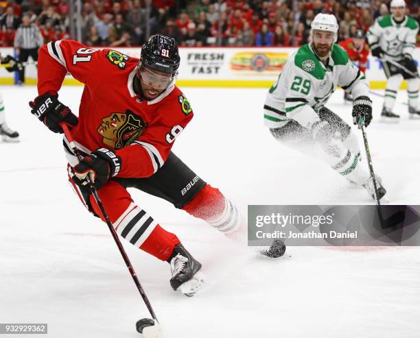 Anthony Duclair of the Chicago Blackhawks advances the puck against Greg Pateryn of the Dallas Stars at the United Center on February 8 2018 in...