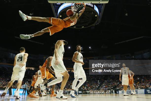 Kerwin Roach II of the Texas Longhorns dunks the ball against the Nevada Wolf Pack during the game in the first round of the 2018 NCAA Men's...