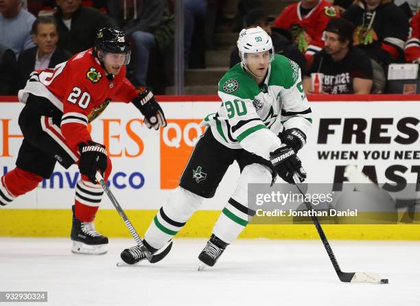 Jason Spezza of the Dallas Stars advances the puck in fromof Brandon Saad of the Chicago Blackhawks at the United Center on February 8 2018 in...