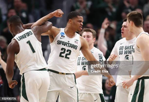 Joshua Langford celebrates with Miles Bridges of the Michigan State Spartans during the first half against the Bucknell Bison in the first round of...