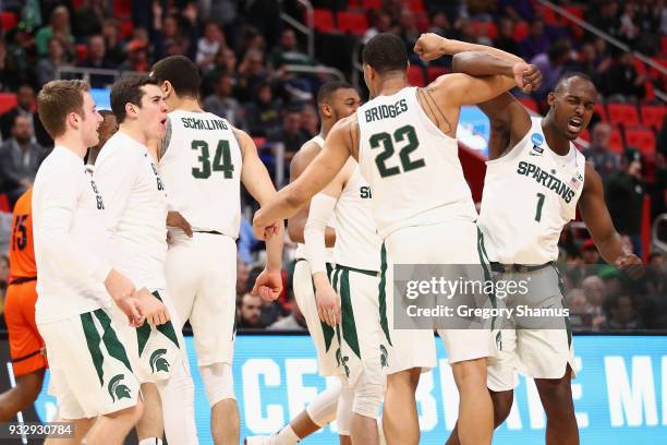 Joshua Langford celebrates with Miles Bridges of the Michigan State Spartans during the first half against the Bucknell Bison in the first round of...