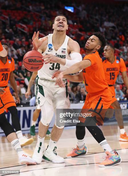 Stephen Brown of the Bucknell Bison strips the ball from Gavin Schilling of the Michigan State Spartans during the first half in the first round of...