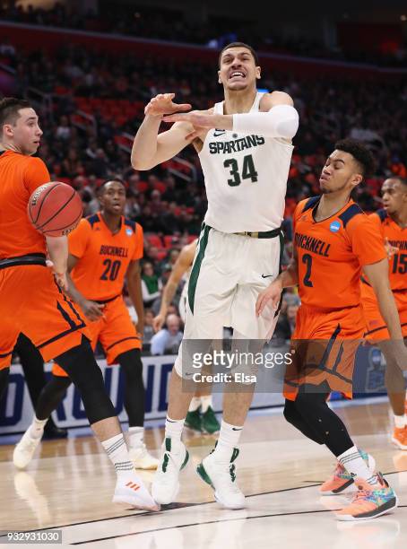 Stephen Brown of the Bucknell Bison strips the ball from Gavin Schilling of the Michigan State Spartans during the first half in the first round of...