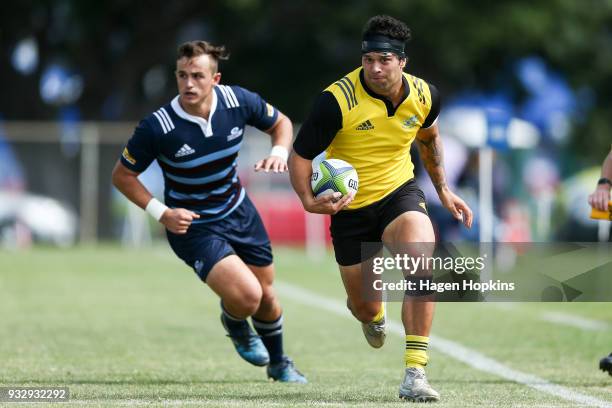 Jonah Lowe of the Hurricanes makes a break from Harry Plummer of the Blues A Team during the development squad trial match between the Hurricanes and...