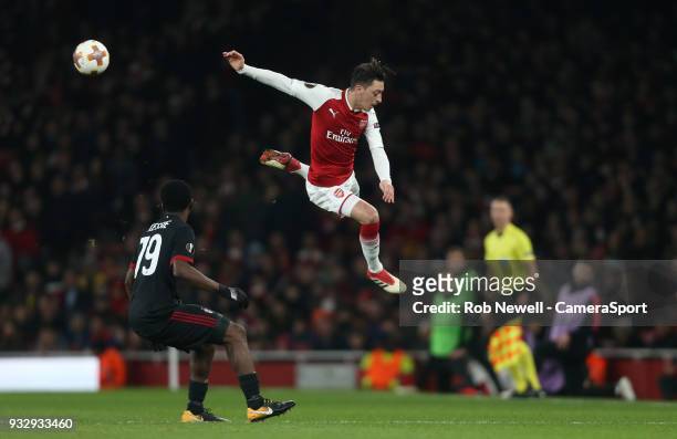 Arsenal's Mesut Ozil with a back flick during the Europa League Round of 16 Second Leg match between Arsenal and AC Milan at Emirates Stadium on...
