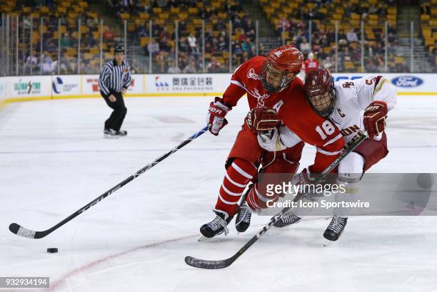 Boston University Terriers forward Jordan Greenway and Boston College Eagles defenseman Casey Fitzgerald in action during a college hockey game...