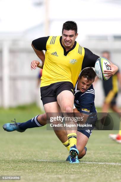 Jackson Garden-Bachop of the Hurricanes is tackled by Harry Plummer of the Blues A Team during the development squad trial match between the...