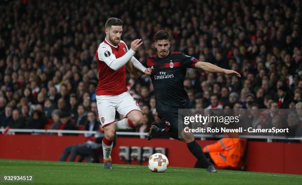 Milan's Andre Silva and Arsenal's Shkodran Mustafi during the Europa League Round of 16 Second Leg match between Arsenal and AC Milan at Emirates...