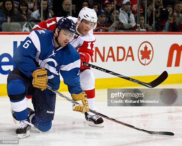 Daniel Cleary of the Detroit Red Wings and Jaroslav Spacek of the Montreal Canadiens battle for position during the NHL game on November 21, 2009 at...