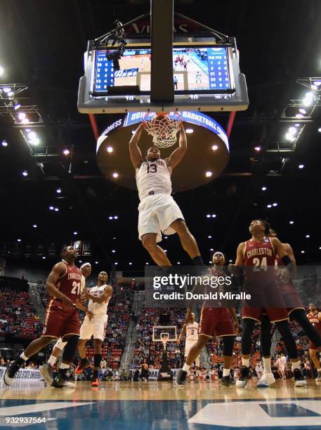 Desean Murray of the Auburn Tigers dunks against Marquise Pointer and Jaylen McManus of the Charleston Cougars in the first half in the first round...