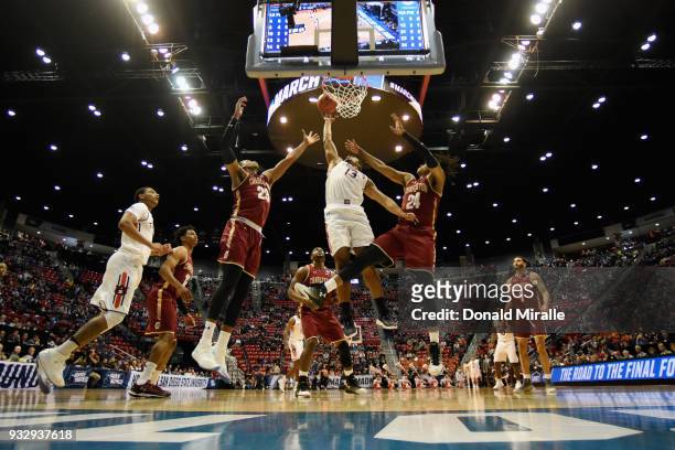 Desean Murray of the Auburn Tigers shoots against Marquise Pointer and Jaylen McManus of the Charleston Cougars in the first half in the first round...