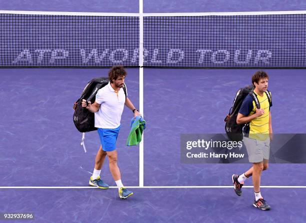 Pablo Cuevas of Uruguay and Horacio Zeballos of Argentina leave the court after their semifinal loss to Bob Bryan and Mike Bryan of the United States...